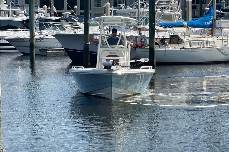 Slide: The Image of 2021 Pathfinder 2600 TRS boat docked in a marina with other vessels. - 3
