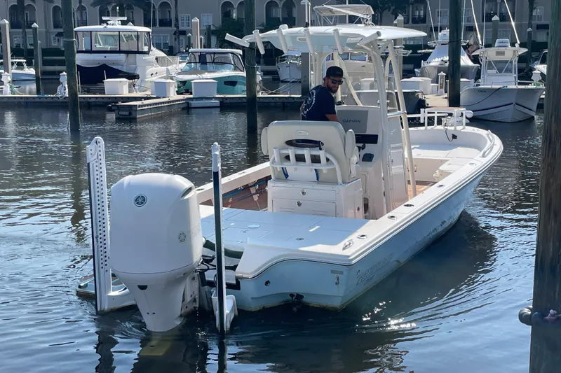 Slide: The Image of 2021 Pathfinder 2600 TRS boat docked in marina with driver onboard. - 6