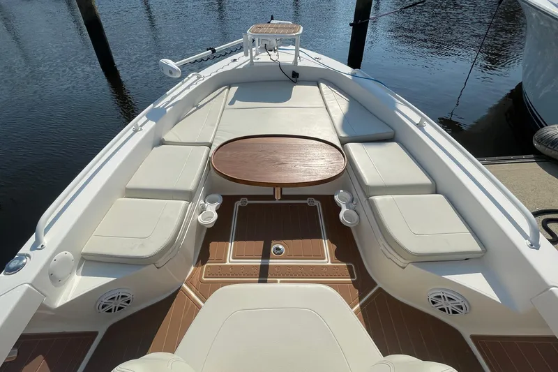 Slide: The Image of 2021 Pathfinder 2600 TRS boat interior with cushioned seating and wooden table. - 9