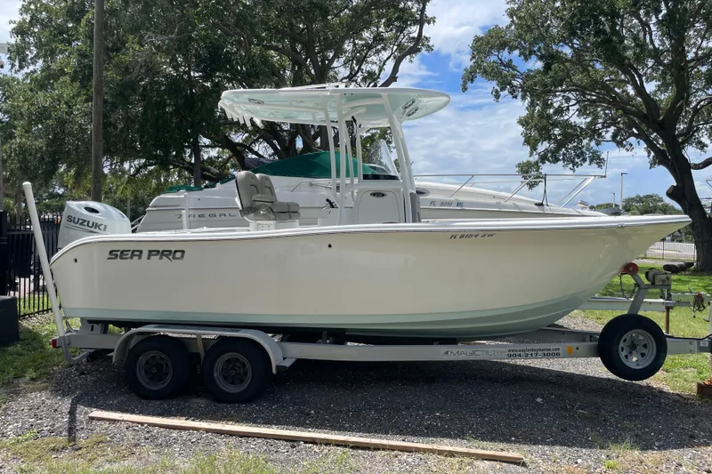 The Image of 2021 Sea Pro 219 Center Console boat on trailer, parked outdoors. - 1