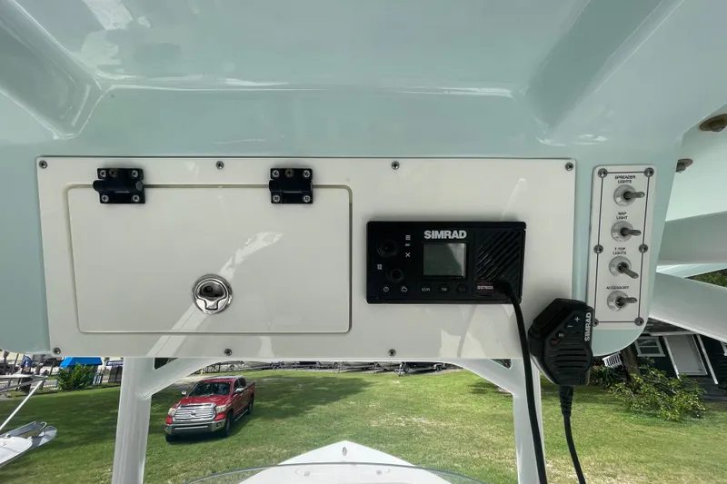 Slide: The Image of 2021 Sea Pro 219 Center Console dashboard with Simrad electronics and control switches. - 11