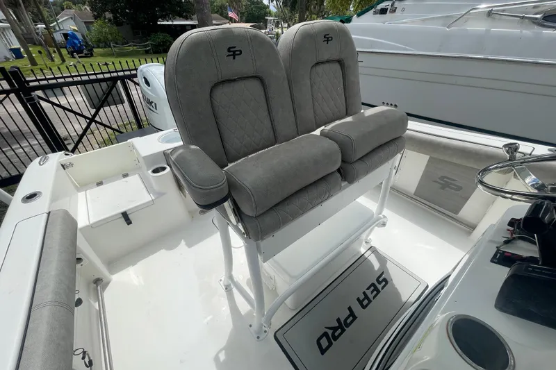 Slide: The Image of 2021 Sea Pro 219 Center Console boat interior with dual seats and steering wheel. - 16