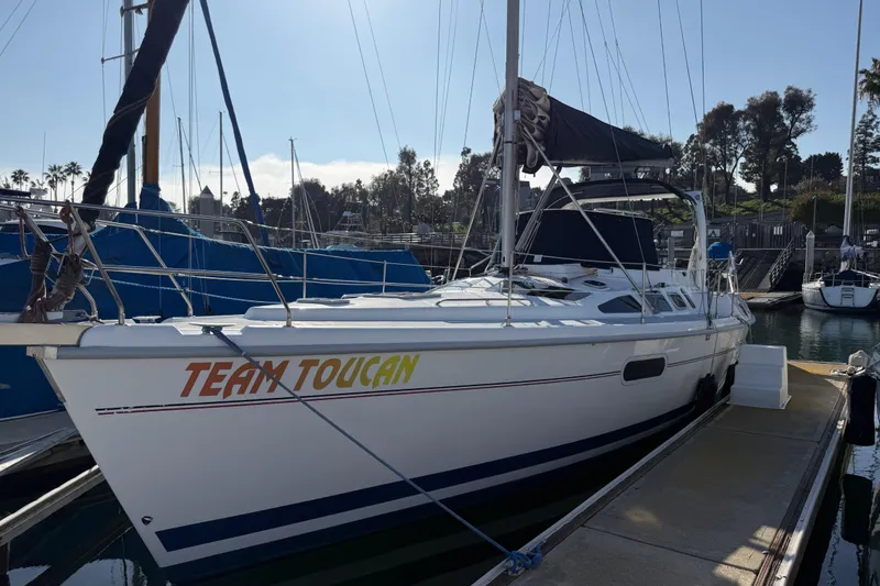 The Image of 1999 Hunter Passage 420 sailboat named "Team Toucan" docked at a marina. - 0