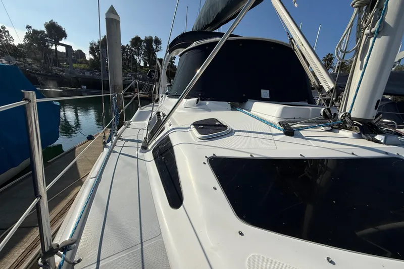 Slide: The Image of 1999 Hunter Passage 420 sailboat docked at marina, side view with rigging details. - 13