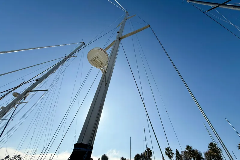 Slide: The Image of Mast of 1999 Hunter Passage 420 sailboat against clear blue sky. - 14