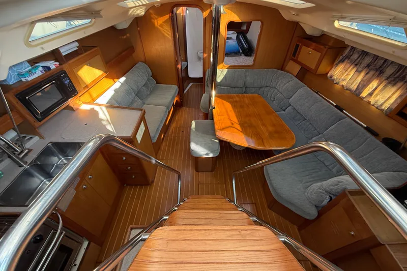 Slide: The Image of Interior of 1999 Hunter Passage 420 yacht with cozy seating and wooden finishes. - 21