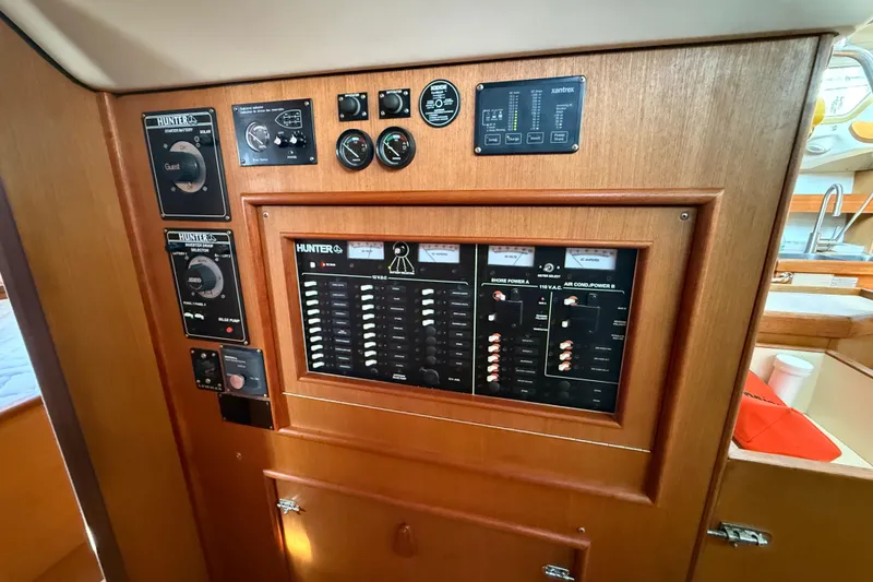 Slide: The Image of Control panel of 1999 Hunter Passage 420 sailboat with various gauges and switches. - 26