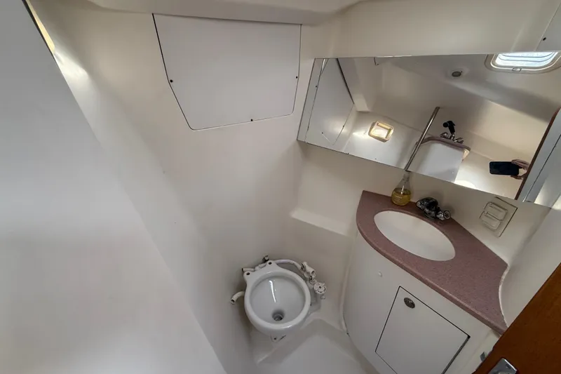Slide: The Image of Bathroom interior of 1999 Hunter Passage 420 yacht, featuring sink and mirror. - 28