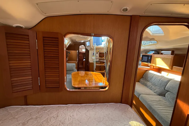 Slide: The Image of Interior of 1999 Hunter Passage 420 yacht with cozy seating and wooden finishes. - 29