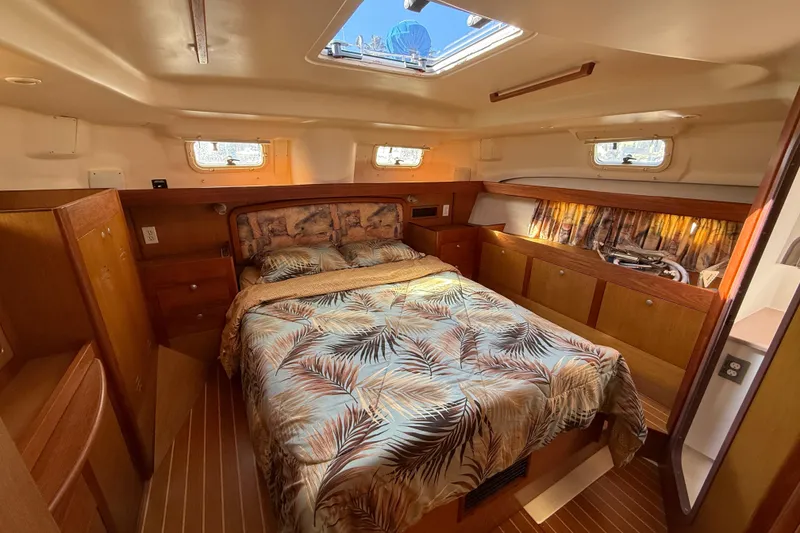 Slide: The Image of 1999 Hunter Passage 420 yacht interior with cozy bedroom and wooden cabinetry. - 30