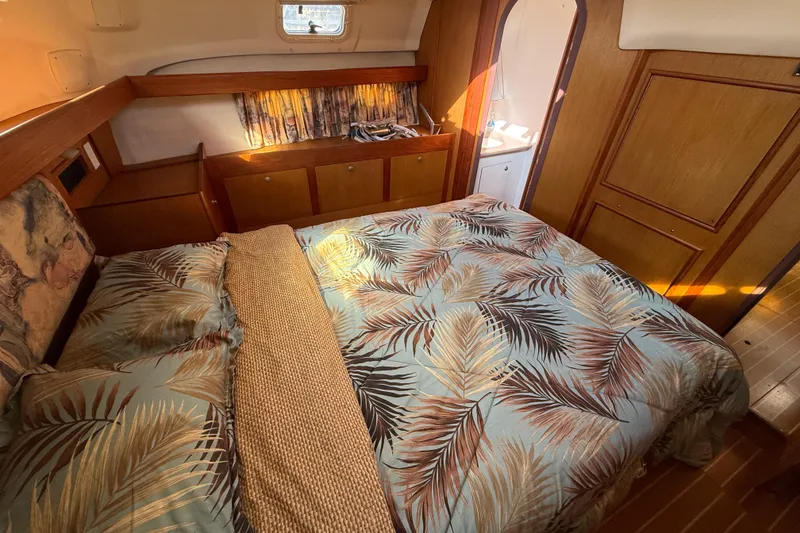 Slide: The Image of Cozy cabin interior of 1999 Hunter Passage 420 sailboat with tropical bedding. - 31