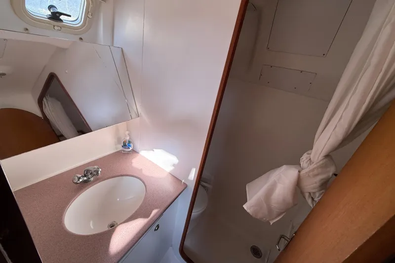 Slide: The Image of Bathroom interior of 1999 Hunter Passage 420 yacht with sink and shower. - 33