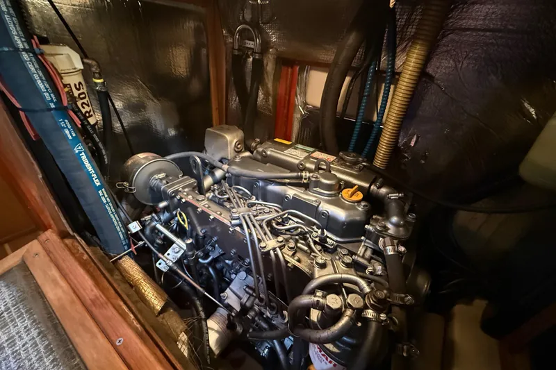 Slide: The Image of Engine compartment of a 1999 Hunter Passage 420 sailboat, showcasing detailed mechanical components. - 34