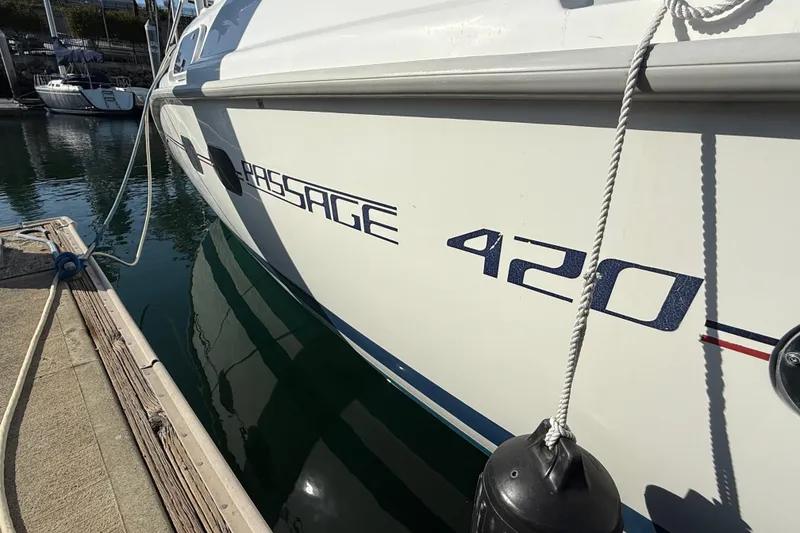 Slide: The Image of Side view of 1999 Hunter Passage 420 yacht docked at marina. - 4