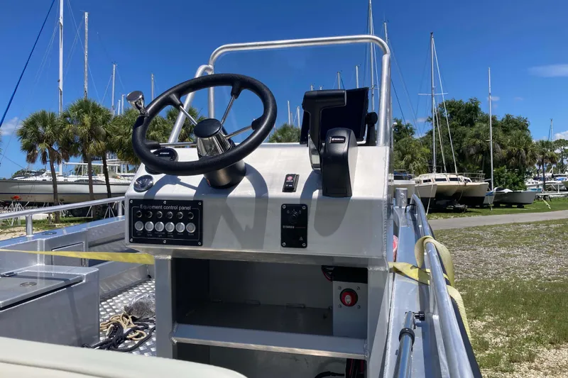 Slide: The Image of Control panel of 2026 Gospel Boat Landing Craft, docked with sailboats in background. - 4