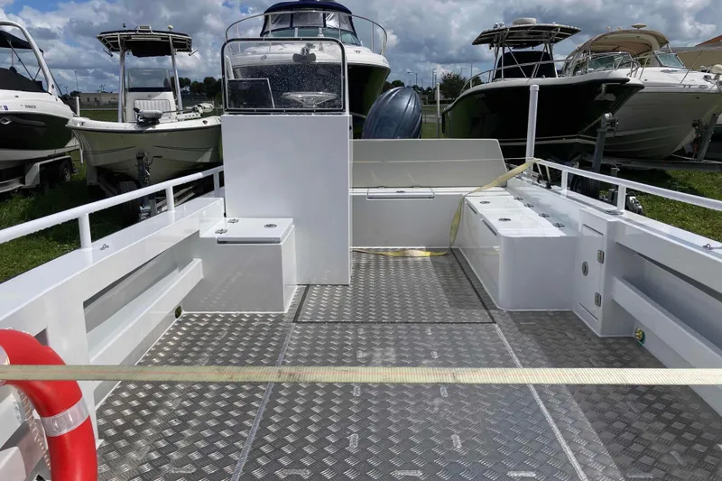 Slide: The Image of 2026 Gospel Boat Landing Craft with spacious deck, surrounded by other boats under a cloudy sky. - 6