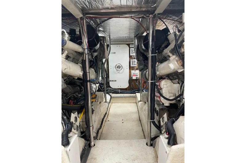 Slide: The Image of Engine room of 1988 Cheoy Lee 58 Convertible yacht, showcasing machinery and equipment. - 10