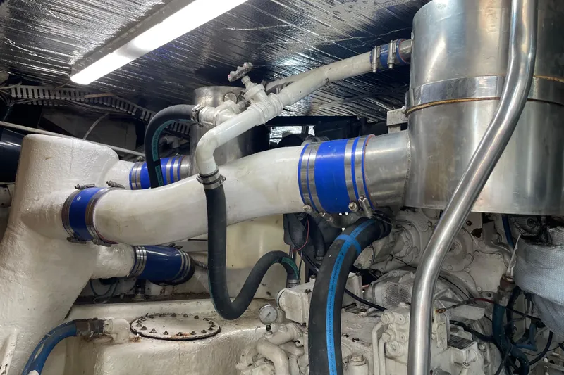 Slide: The Image of Engine room of 1988 Cheoy Lee 58 Convertible yacht with visible pipes and machinery. - 13
