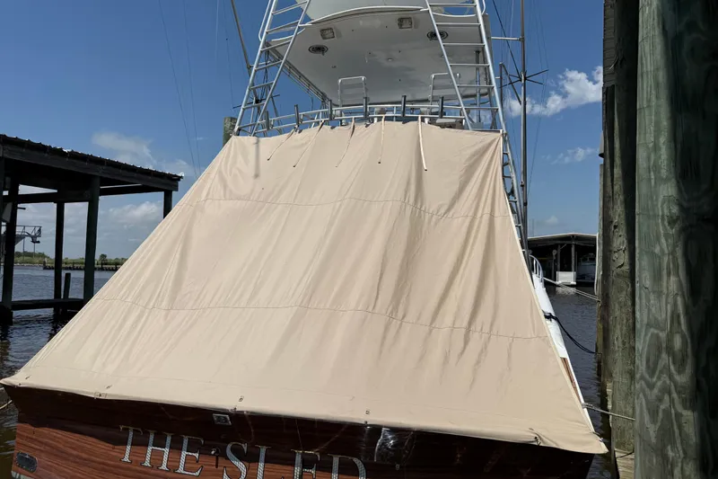 Slide: The Image of 1988 Cheoy Lee 58 Convertible yacht with beige cover docked at marina. - 15