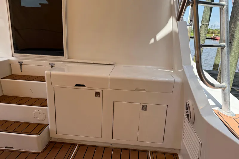 Slide: The Image of 1988 Cheoy Lee 58 Convertible yacht interior with wooden steps and storage cabinets. - 18