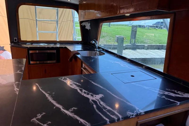 Slide: The Image of Luxurious kitchen interior of 1988 Cheoy Lee 58 Convertible yacht with marble countertops. - 20
