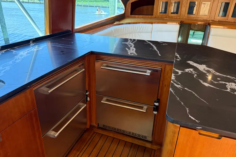 Slide: The Image of Luxurious 1988 Cheoy Lee 58 Convertible yacht interior with sleek kitchen design and modern appliances. - 26