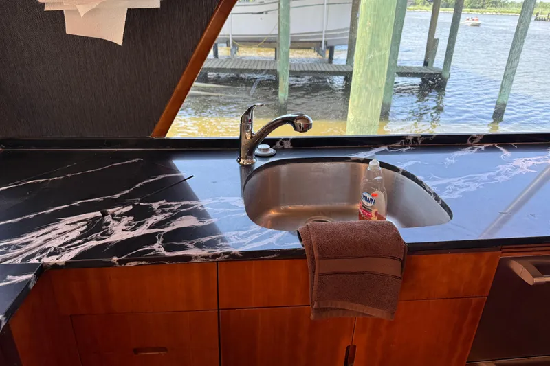Slide: The Image of Kitchen sink area on 1988 Cheoy Lee 58 Convertible yacht with marble countertop. - 27