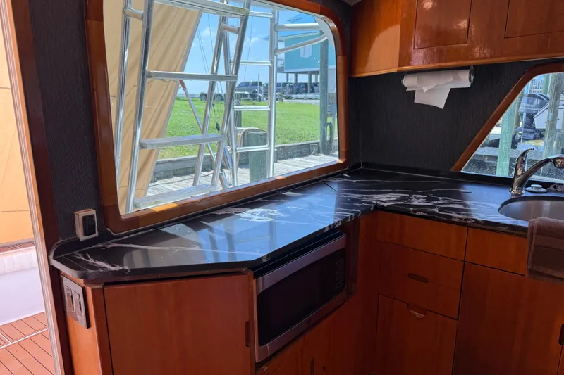 Slide: The Image of Interior of 1988 Cheoy Lee 58 Convertible yacht with marble countertop and wooden cabinetry. - 28