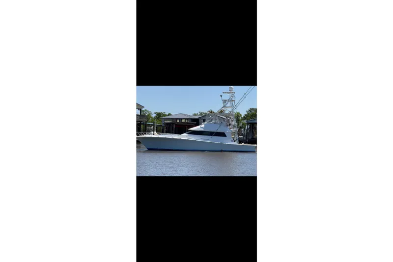 Slide: The Image of 1988 Cheoy Lee 58 Convertible yacht docked on calm water. - 3