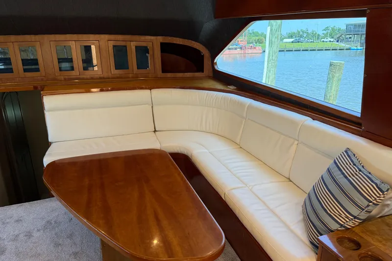 Slide: The Image of Luxurious interior of 1988 Cheoy Lee 58 Convertible yacht with white seating and wooden table. - 30