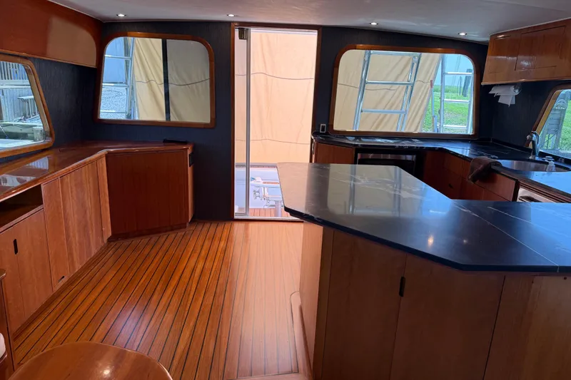 Slide: The Image of 1988 Cheoy Lee 58 Convertible yacht interior with wooden flooring and modern kitchen. - 31