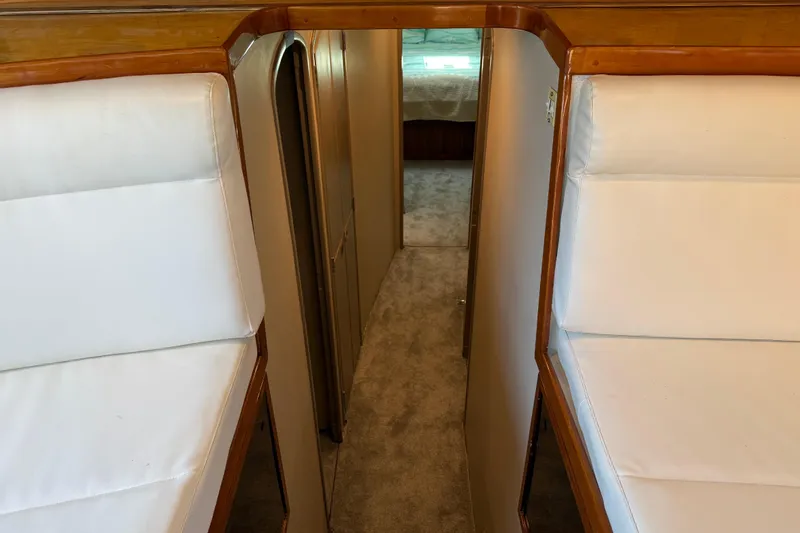 Slide: The Image of Interior view of 1988 Cheoy Lee 58 Convertible yacht with white cushioned seating. - 34