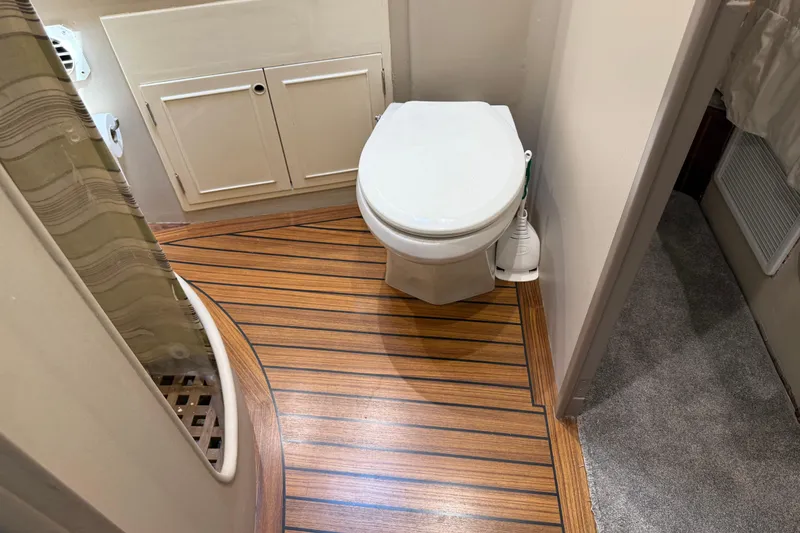 Slide: The Image of 1988 Cheoy Lee 58 Convertible yacht bathroom with wooden flooring and white fixtures. - 38