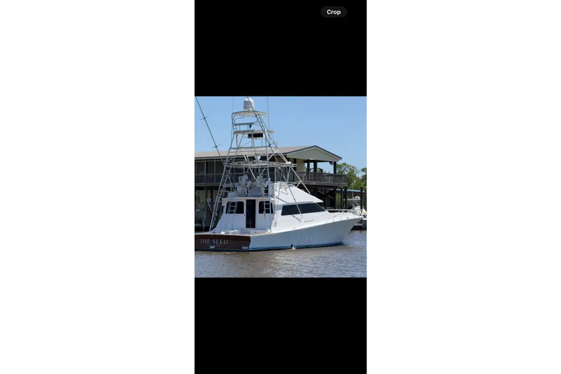 Slide: The Image of 1988 Cheoy Lee 58 Convertible yacht docked by a marina. - 4