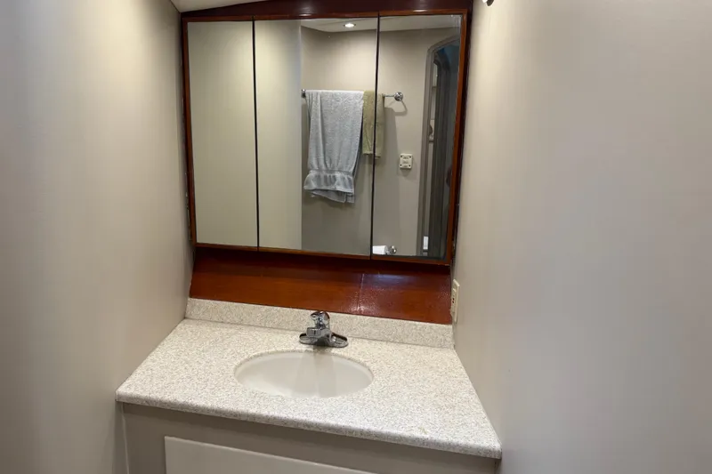 Slide: The Image of Bathroom vanity with mirror and sink in 1988 Cheoy Lee 58 Convertible yacht. - 40
