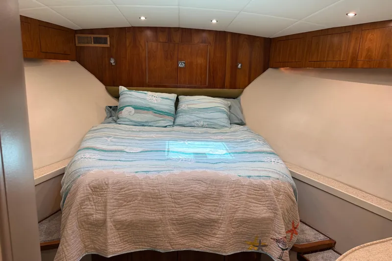 Slide: The Image of 1988 Cheoy Lee 58 Convertible yacht bedroom with cozy bedding and wooden accents. - 41