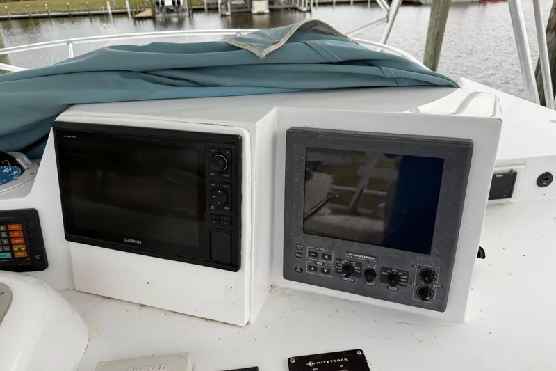 Slide: The Image of Control panel of a 1988 Cheoy Lee 58 Convertible yacht with navigation equipment. - 55