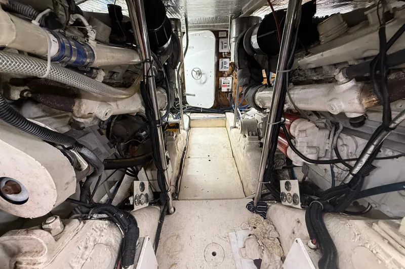 Slide: The Image of Engine room of 1988 Cheoy Lee 58 Convertible yacht, showcasing mechanical components. - 57