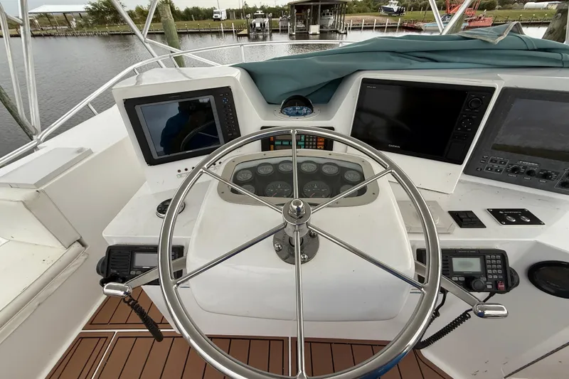 Slide: The Image of Helm of 1988 Cheoy Lee 58 Convertible yacht with navigation equipment and steering wheel. - 66
