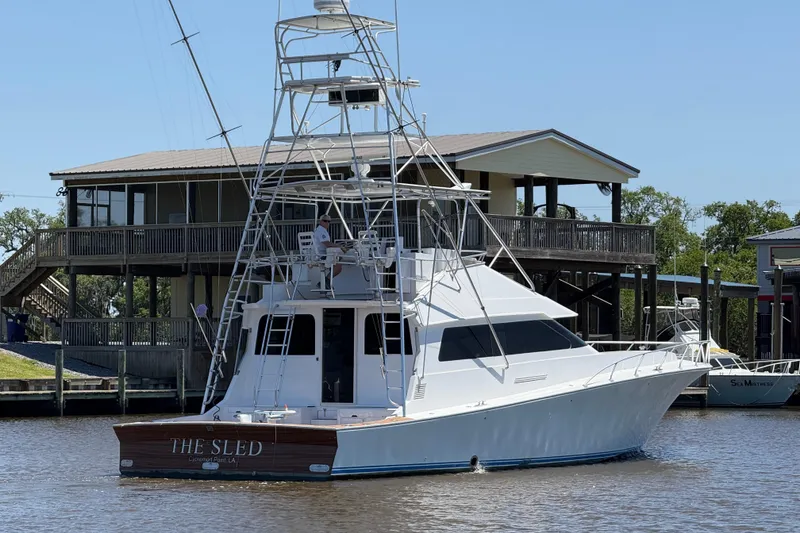 Slide: The Image of 1988 Cheoy Lee 58 Convertible yacht docked near waterfront house. - 7