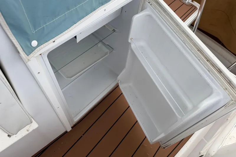 Slide: The Image of Open refrigerator on 1988 Cheoy Lee 58 Convertible yacht, showing interior shelves. - 73
