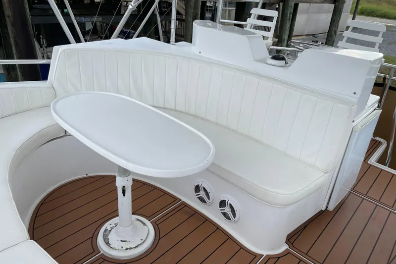 Slide: The Image of White seating area on 1988 Cheoy Lee 58 Convertible yacht with wooden deck. - 74