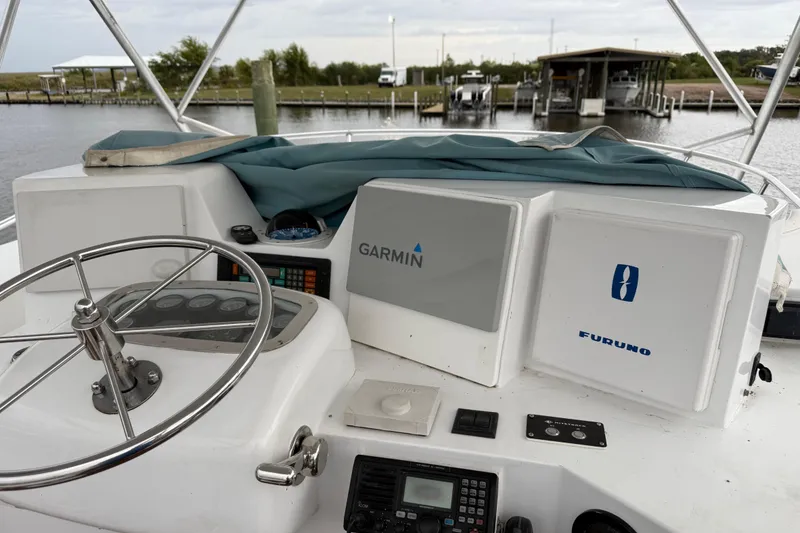 Slide: The Image of Helm of 1988 Cheoy Lee 58 Convertible with Garmin and Furuno navigation systems. - 76