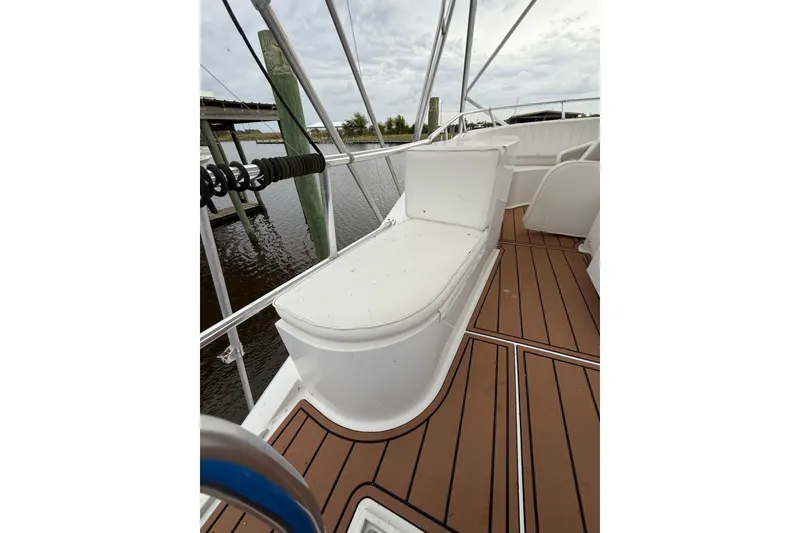 Slide: The Image of 1988 Cheoy Lee 58 Convertible yacht deck with cushioned seating and wooden flooring. - 79