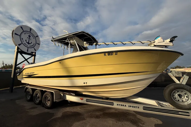 The Image of 2003 Hydra-Sports Vector 2600 CC boat on trailer, displayed outdoors under clear sky. - 0