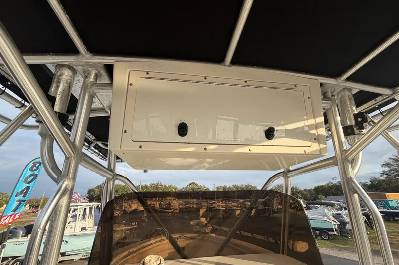 Slide: The Image of 2003 Hydra-Sports Vector 2600 CC boat interior with steering console and rod holders. - 18