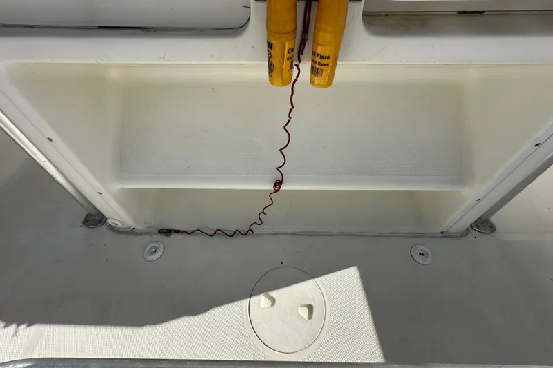 Slide: The Image of Open storage compartment on 2003 Hydra-Sports Vector 2600 CC boat, showing interior contents. - 36