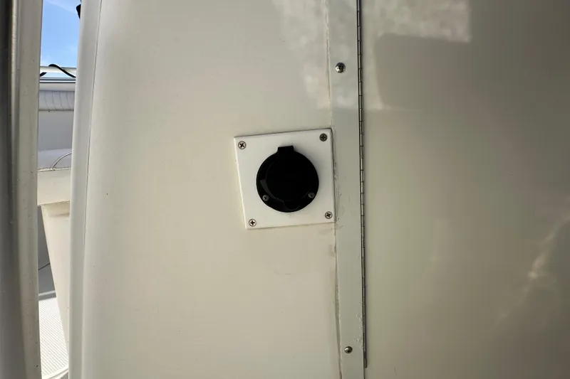 Slide: The Image of 2003 Hydra-Sports Vector 2600 CC boat interior with white seating and speakers. - 44