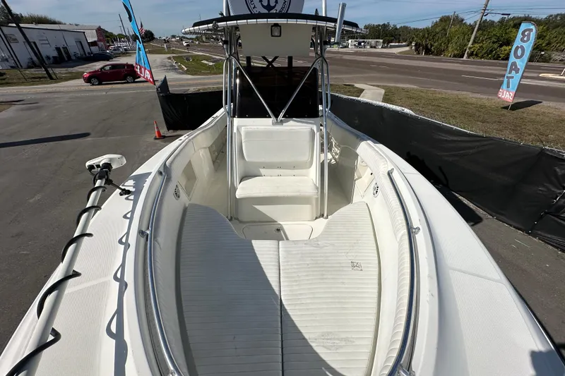 Slide: The Image of 2003 Hydra-Sports Vector 2600 CC boat interior with seating and T-top, parked near road. - 64