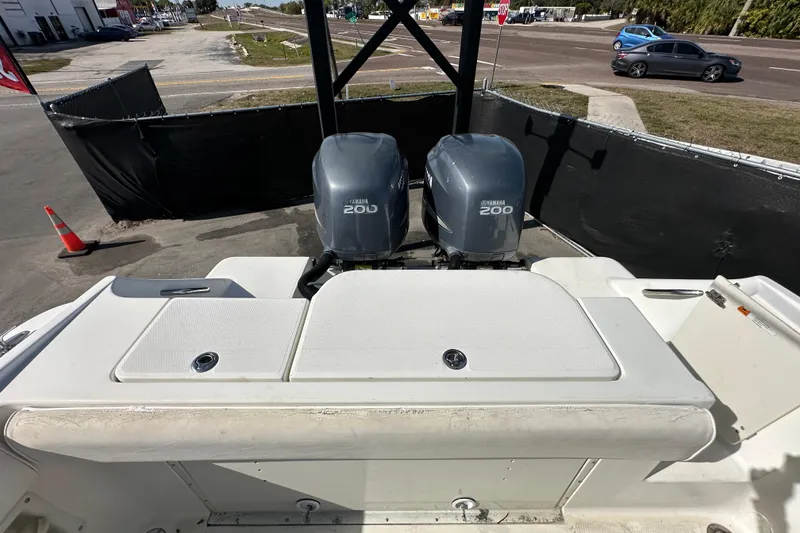 Slide: The Image of 2003 Hydra-Sports Vector 2600 CC boat deck with storage compartment and dual engines. - 77